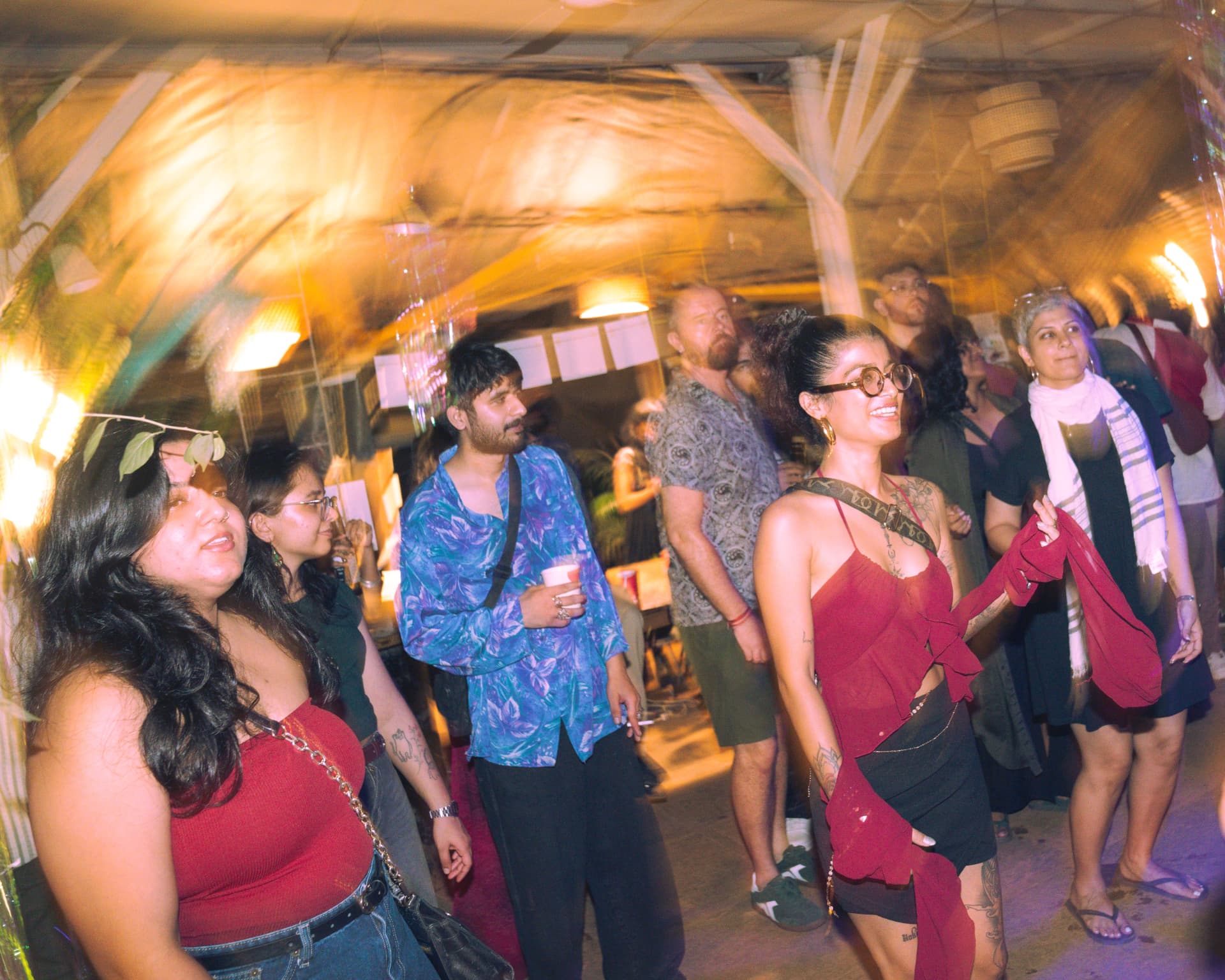 Guests laughing together in golden light at the venue