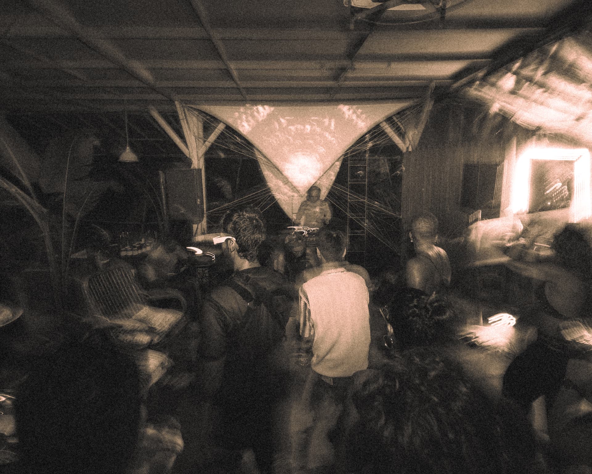 Sepia-toned crowd gathered around the stage