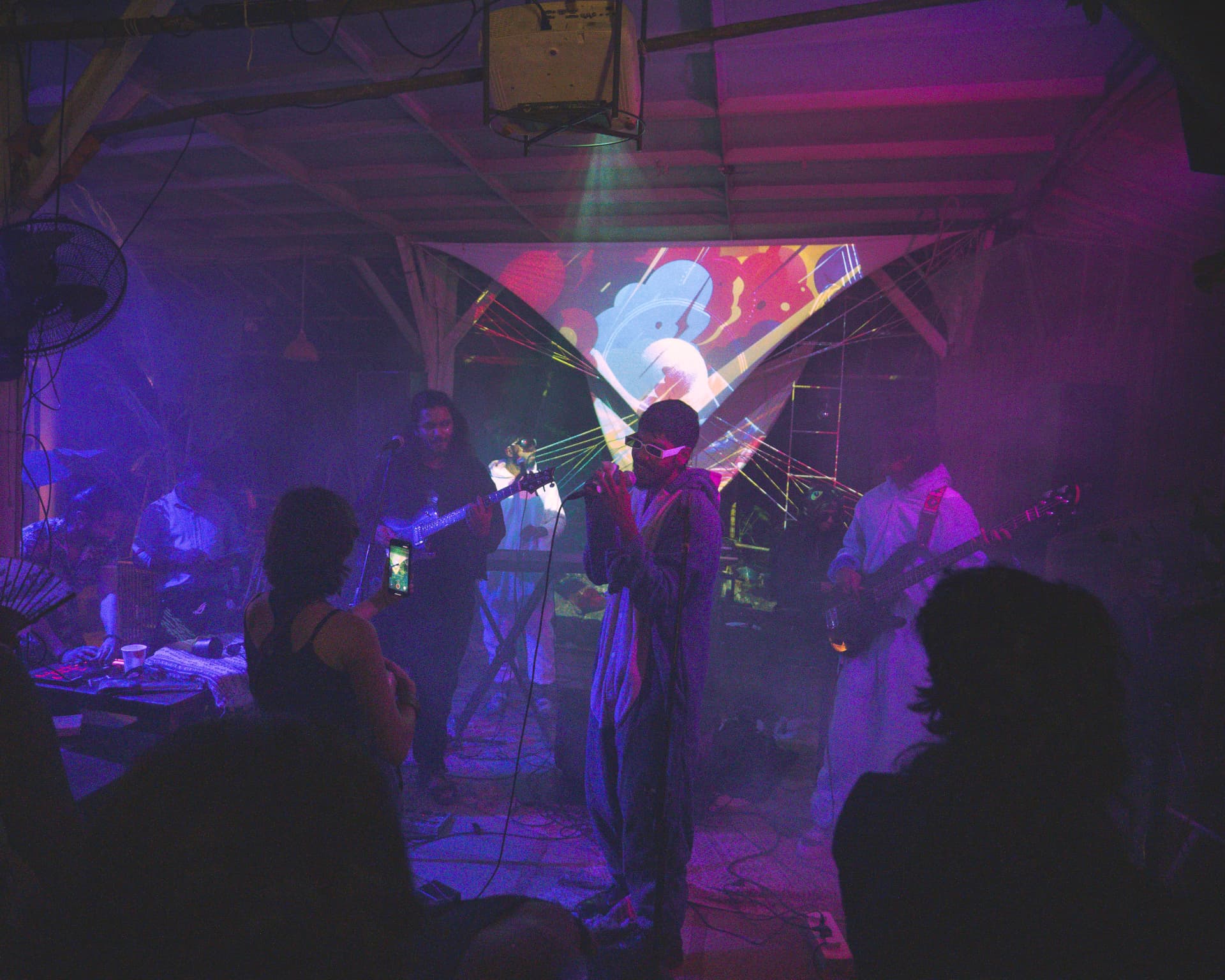 Full band set with projections and haze filling the venue
